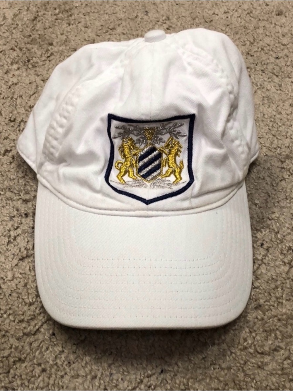 J. Crew White Hat with embroidered lions and has elastic band